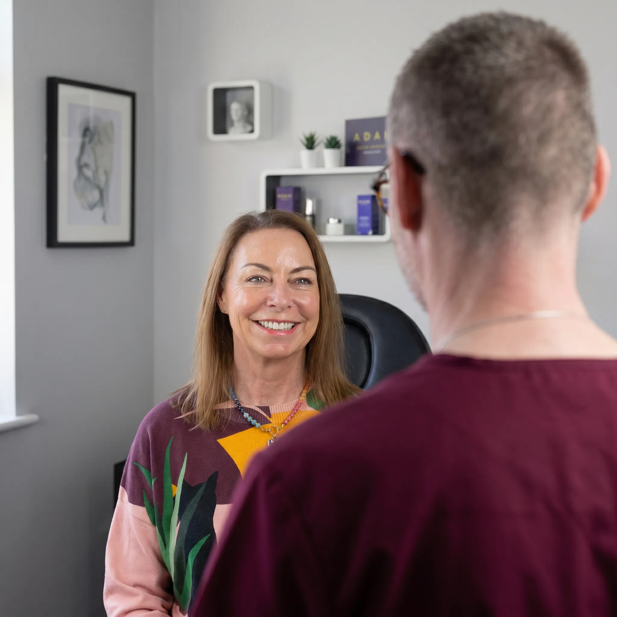 Adam in consult with a female client