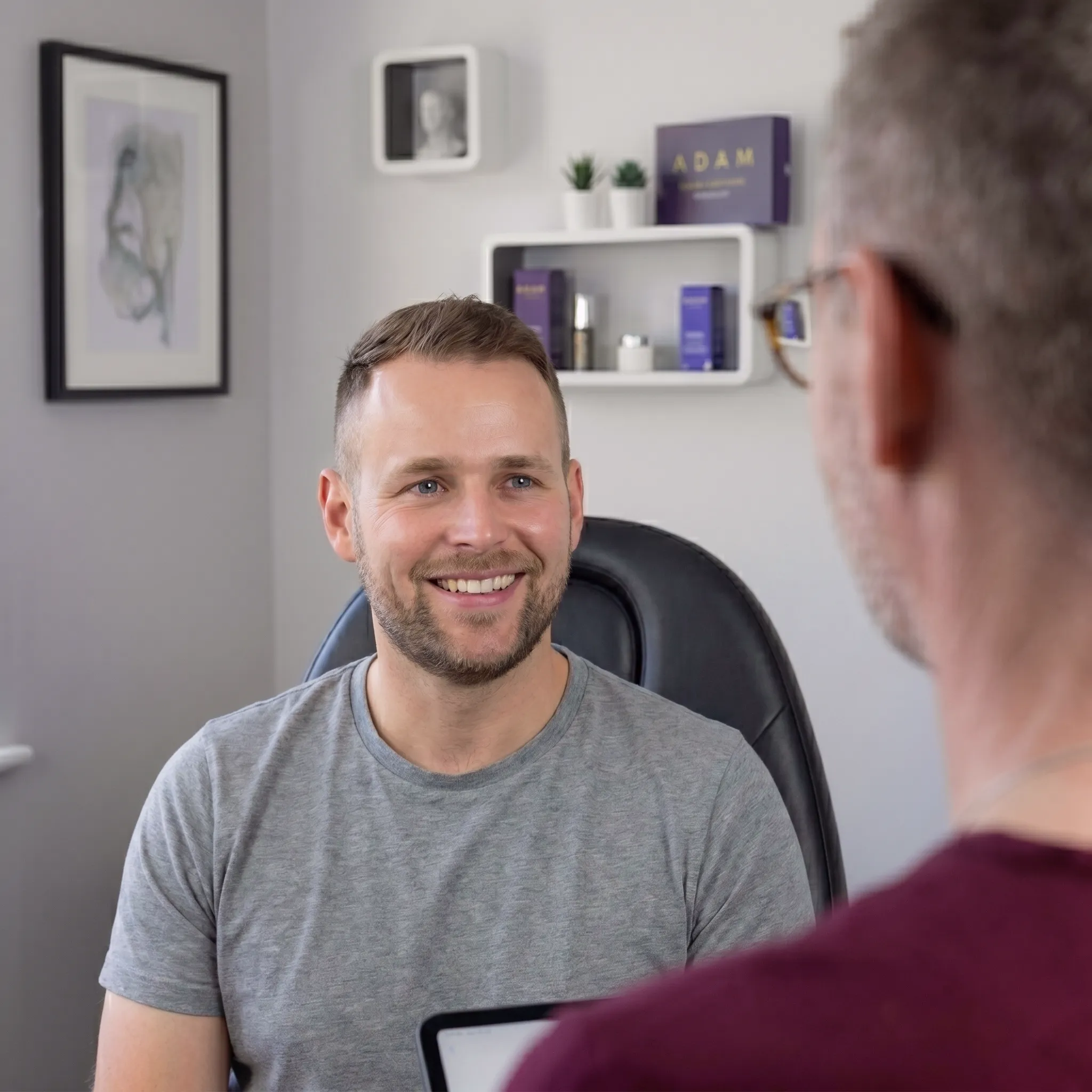 Adam in consultation with a male client