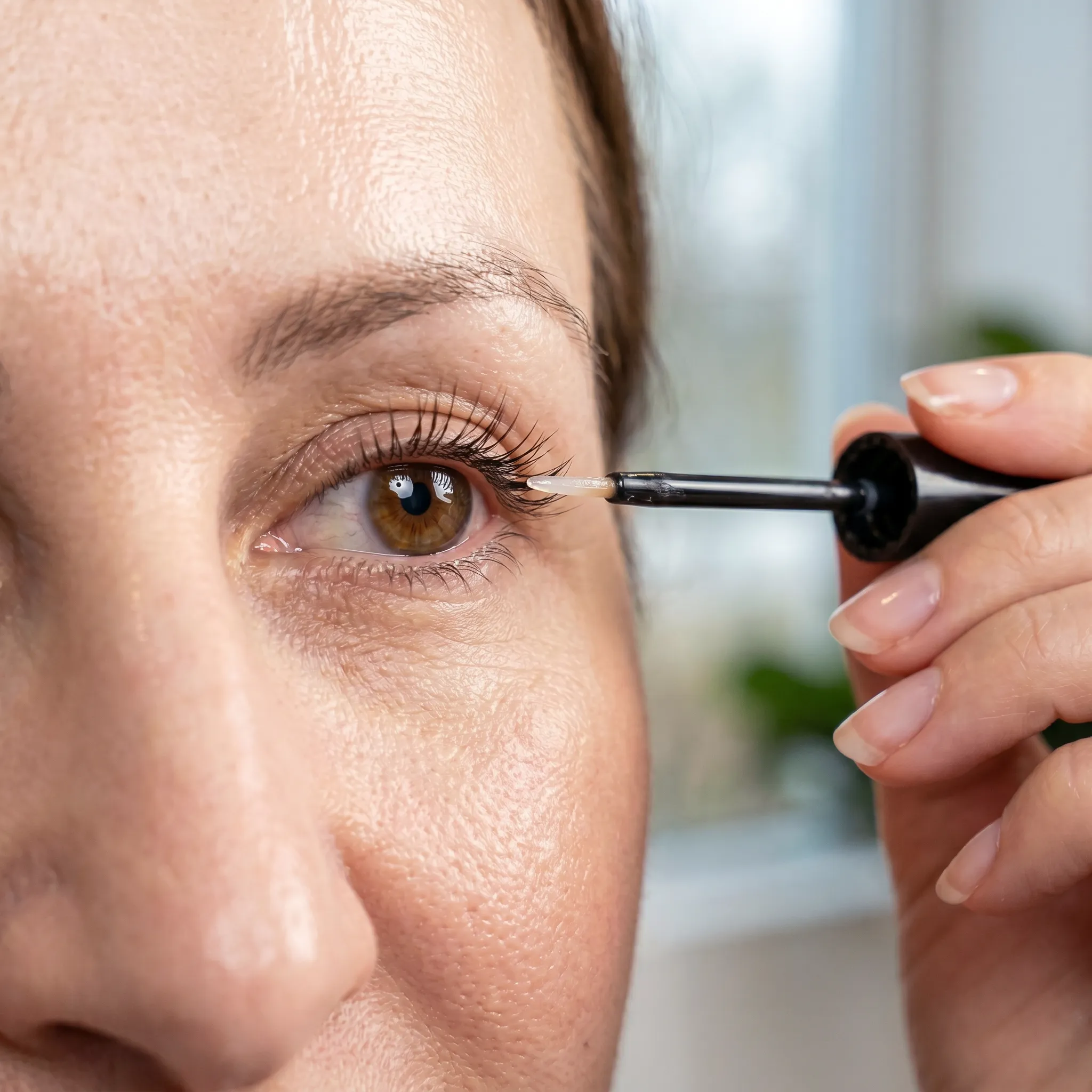 a female client with enhanced eyelashes following use of eyelash serum